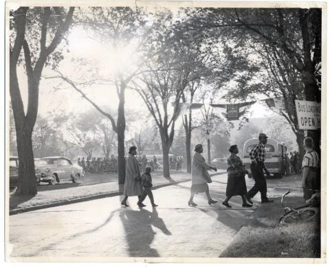People walking on a street in a neighborhood