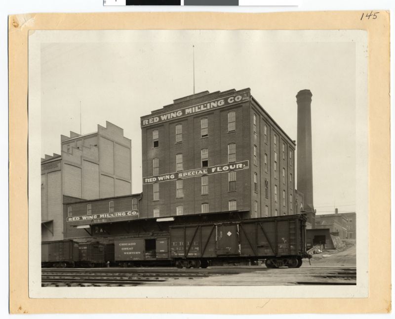 Large, brick building with banner labeled "Red Wing Milling Co." Underneath states "Red Wing Special Flour"