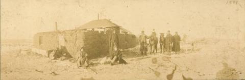 Sod house with people and horses, near Holloway, Minnesota