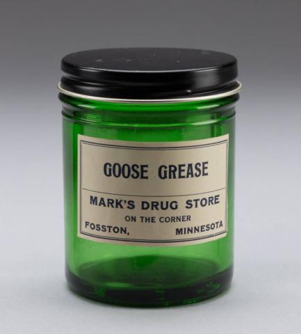 Green glass jar for Goose Grease from Mark's Drug Store, Fosston, Minnesota