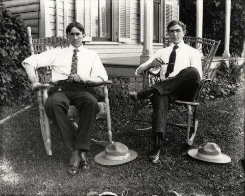 Lincoln and Frank Fey seated outside in rocking chairs