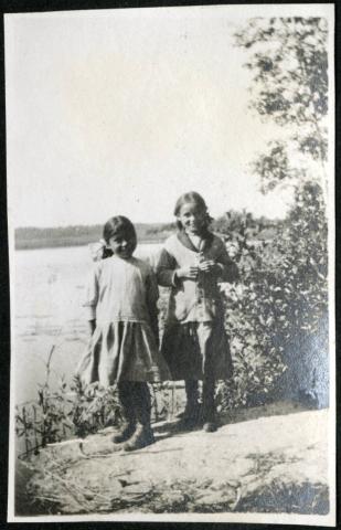 Ojibwe girls on the shore of a lake