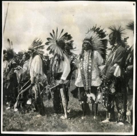 Ojibwe and Dakota men in a pipe ceremony