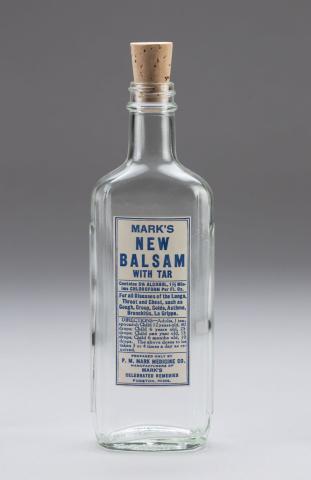 Clear glass medicine bottle labeled Marks' New Balsam with Tar