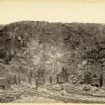 Minnesota Mine open pit with workers and railroad tracks in Tower, Minnesota, 1885